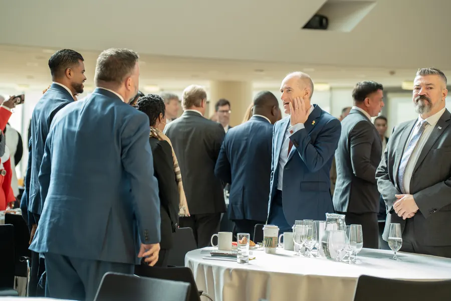 Delegates networking in the forum hall