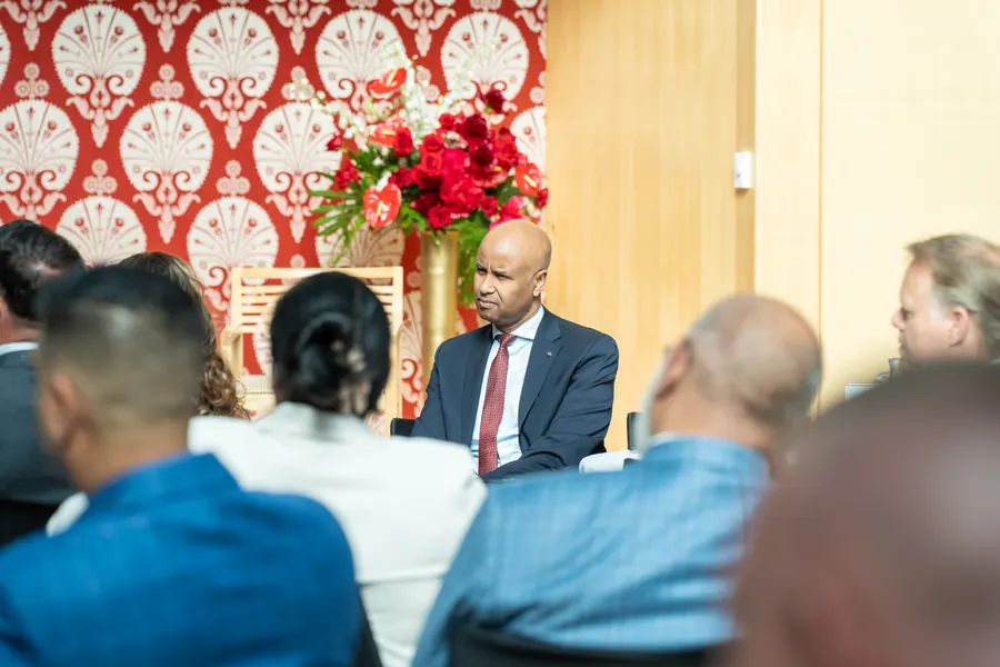 Guests seated beside the floral displays