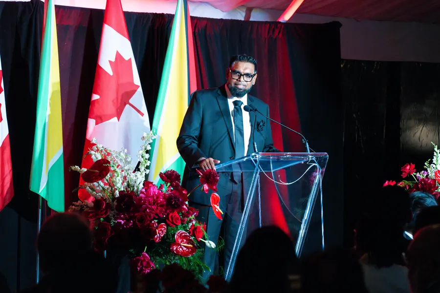 H.E. Dr. Mohamed Irfaan Ali, President of Guyana, on stage at the gala
